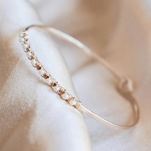 gold filled, freshwater pearl bangle bracelet on a white background 