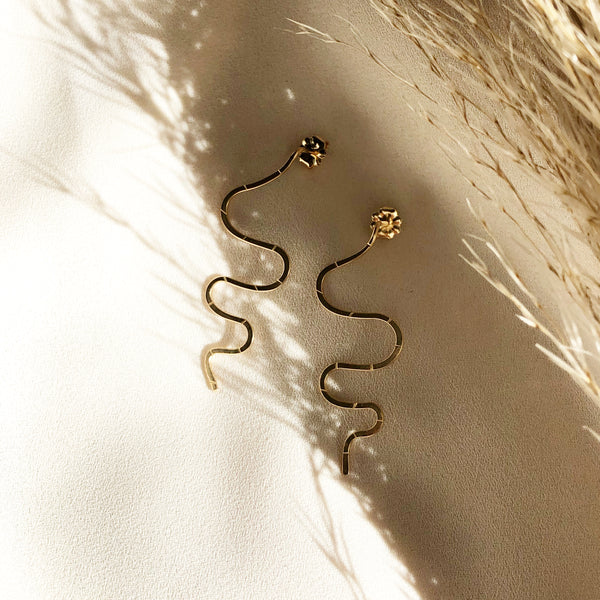 handmade, gold snake earrings, in the sunlight 