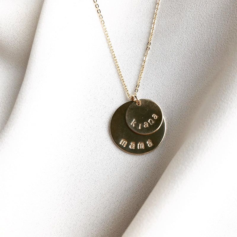 double disc necklace which is customizable, this gold necklace is stamped with the names Kiana and Mama 