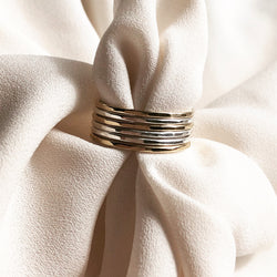 handmade gold and sterling silver stacking  rings, placed on a piece of fabirc
