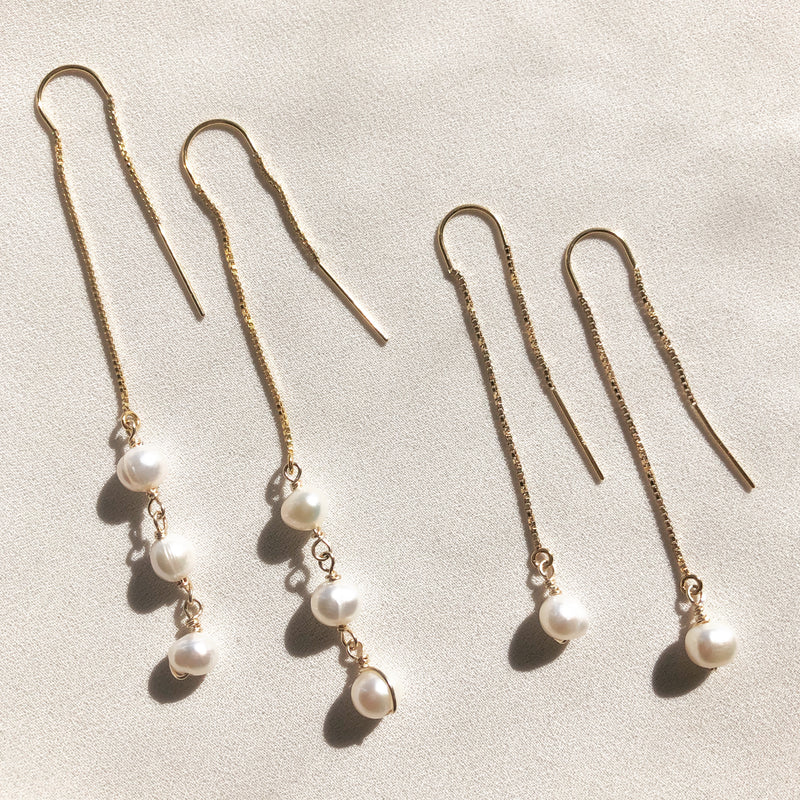 Unique threader earrings with white, freshwater pearl detail.